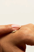 Load image into Gallery viewer, Lips Vulva Balm by Peach and Cream ®, held in hand for size comparison
