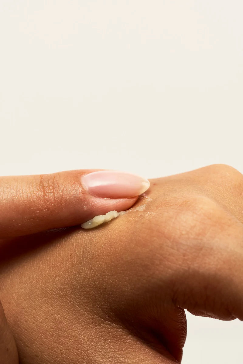 Lips Vulva Balm by Peach and Cream ®, held in hand for size comparison